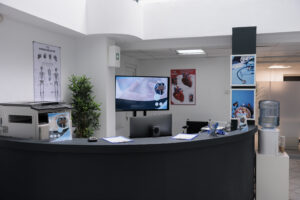 nobody in hospital waiting room front desk with office supplies and promotional flyers